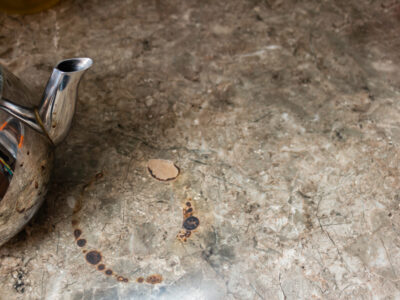 Laminate kitchen countertop has burn damage due to a hot teapot