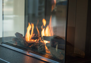 Fire burns in a natural gas glass fireplace