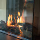 Fire burns in a natural gas glass fireplace