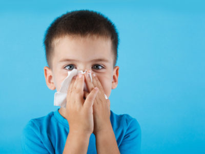 Small child blowing his nose