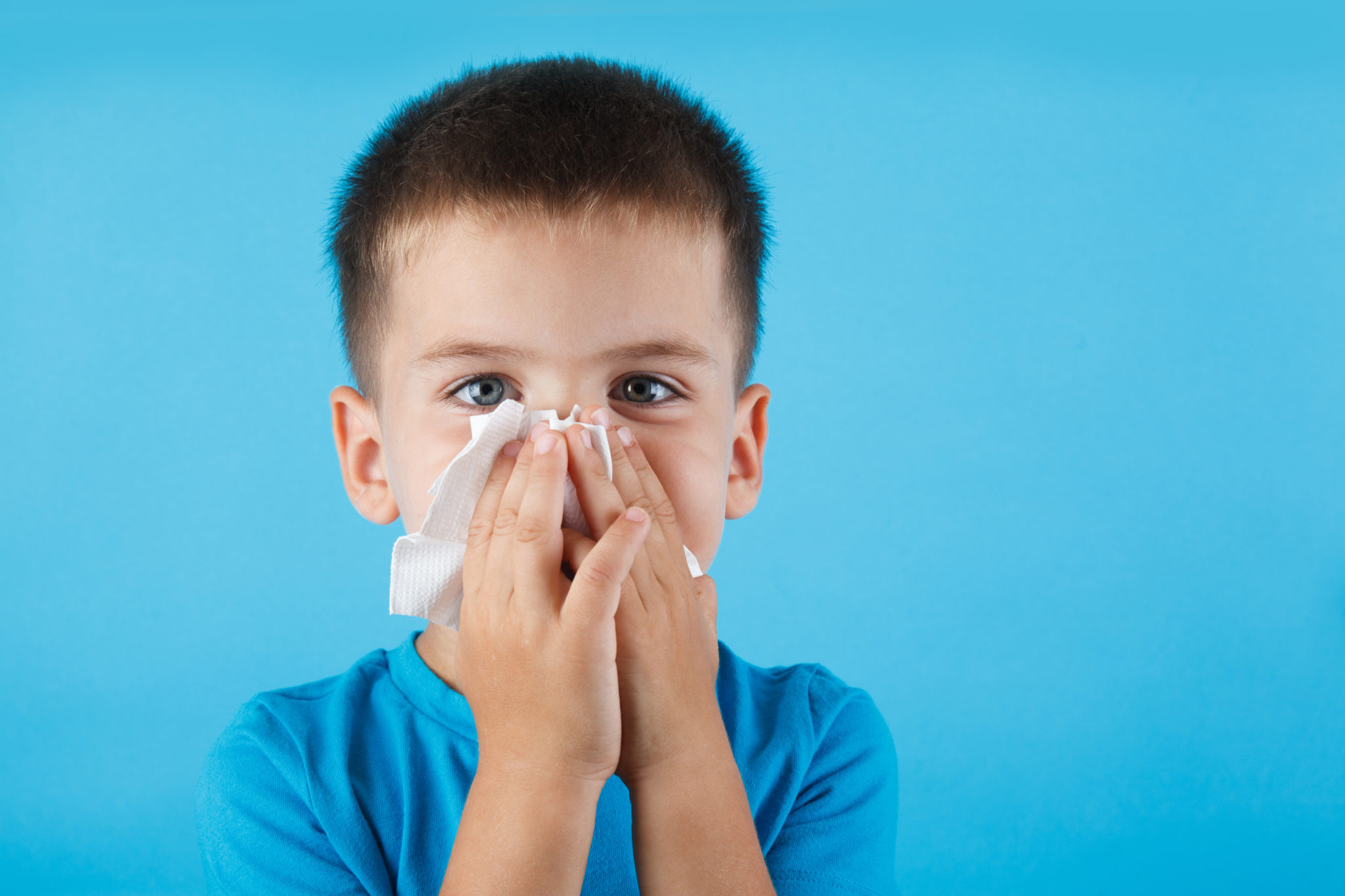 Small child blowing his nose