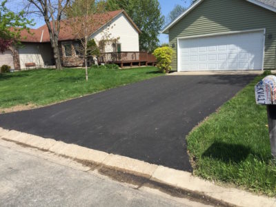 Asphalt driveway leading to garage