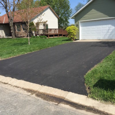 Asphalt driveway leading to garage