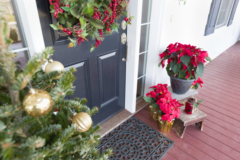 Gray front door decorated for the holidays