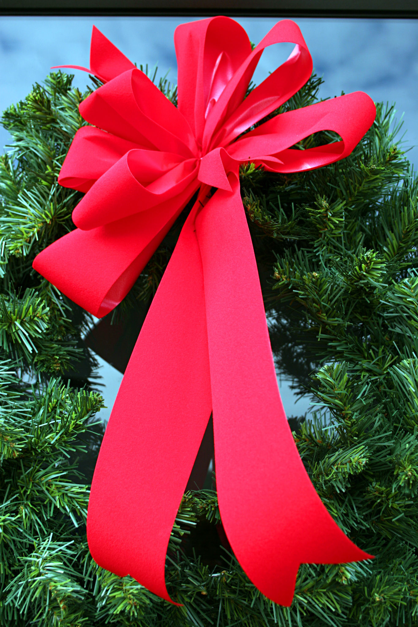 Red holiday bow on door