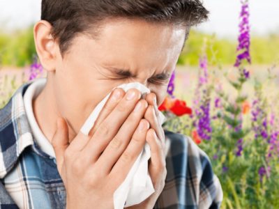 Man sneezing from allergies