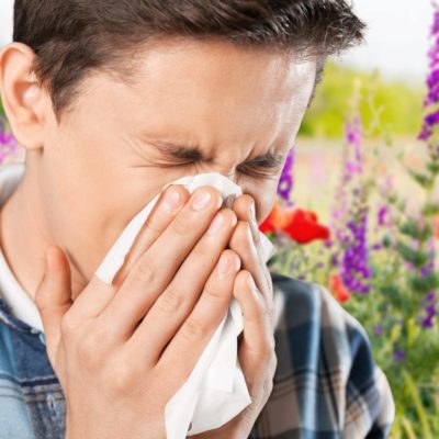 Man sneezing from allergies