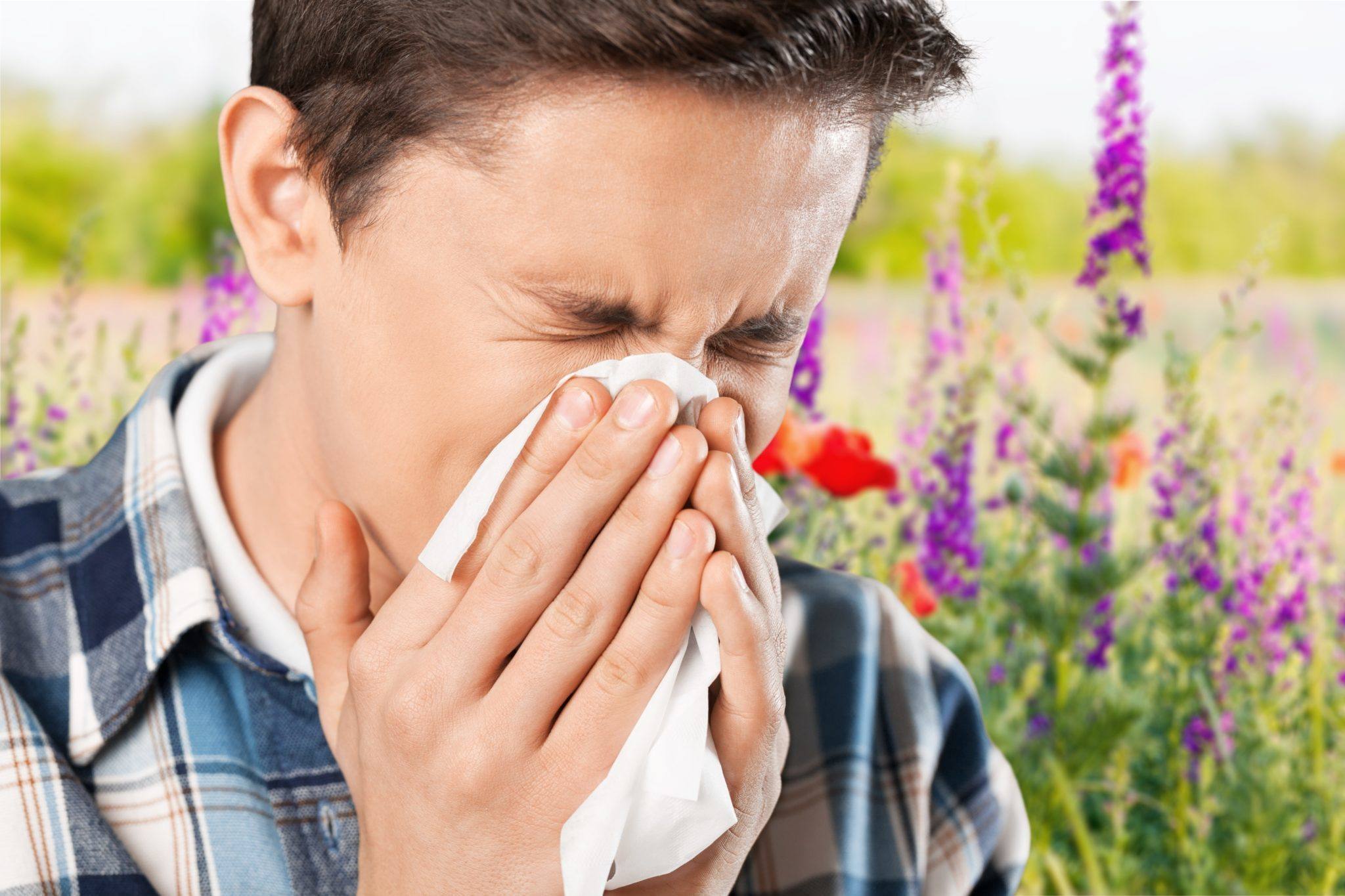 Man sneezing from allergies