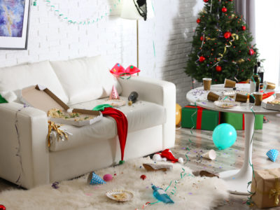 Messy living room interior with Christmas tree