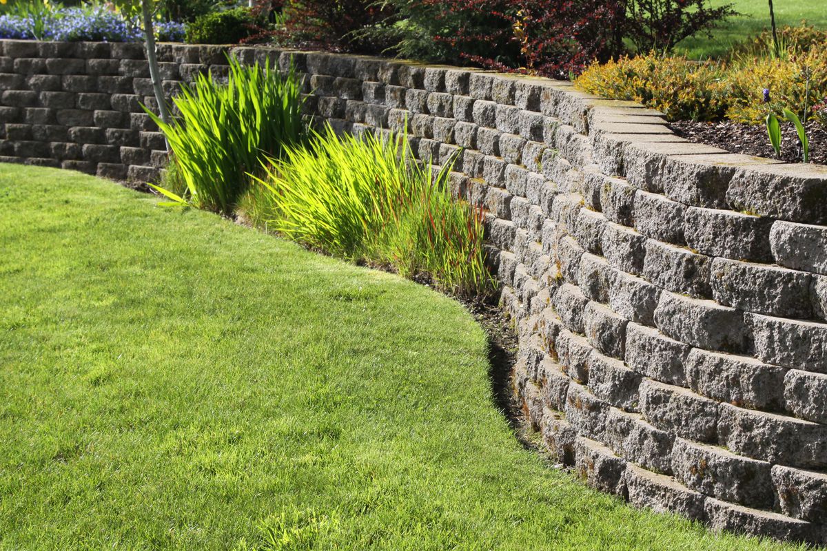 retaining wall with grass and landscape