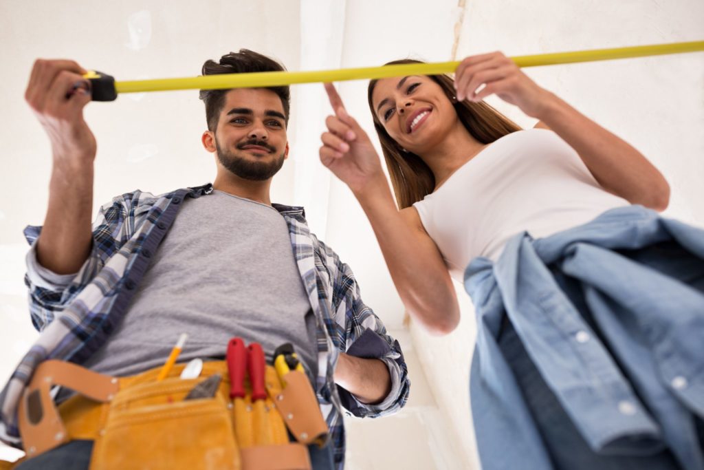 Young couple taking measurements