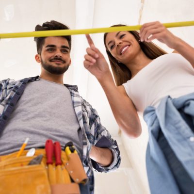 Young couple taking measurements