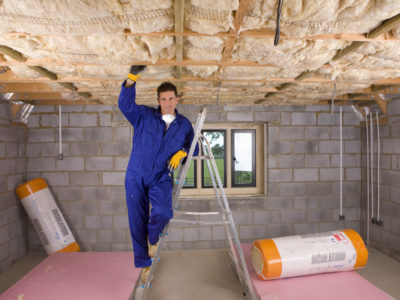 Man installing floor insulation