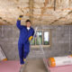 Man installing floor insulation