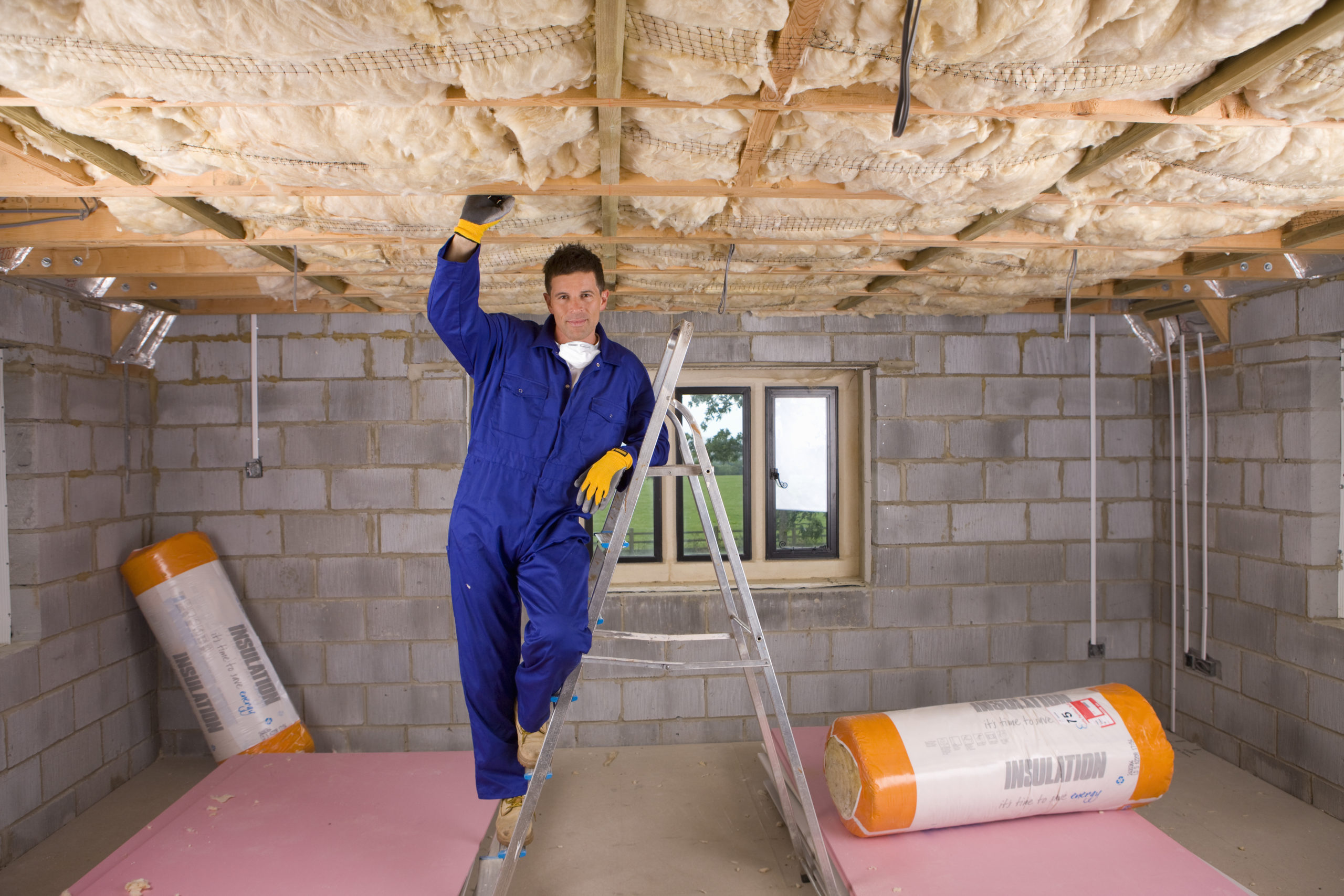 Man installing floor insulation