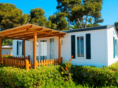 Closeup of a mobile home with a deck lanai