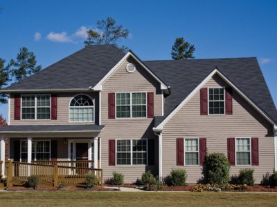 house with shutters over vinyl siding