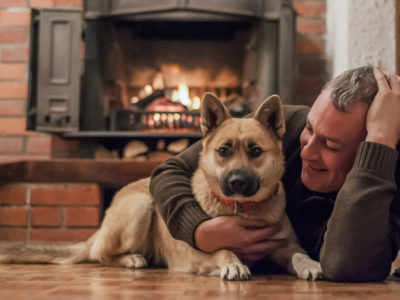 Man with dog and fireplace