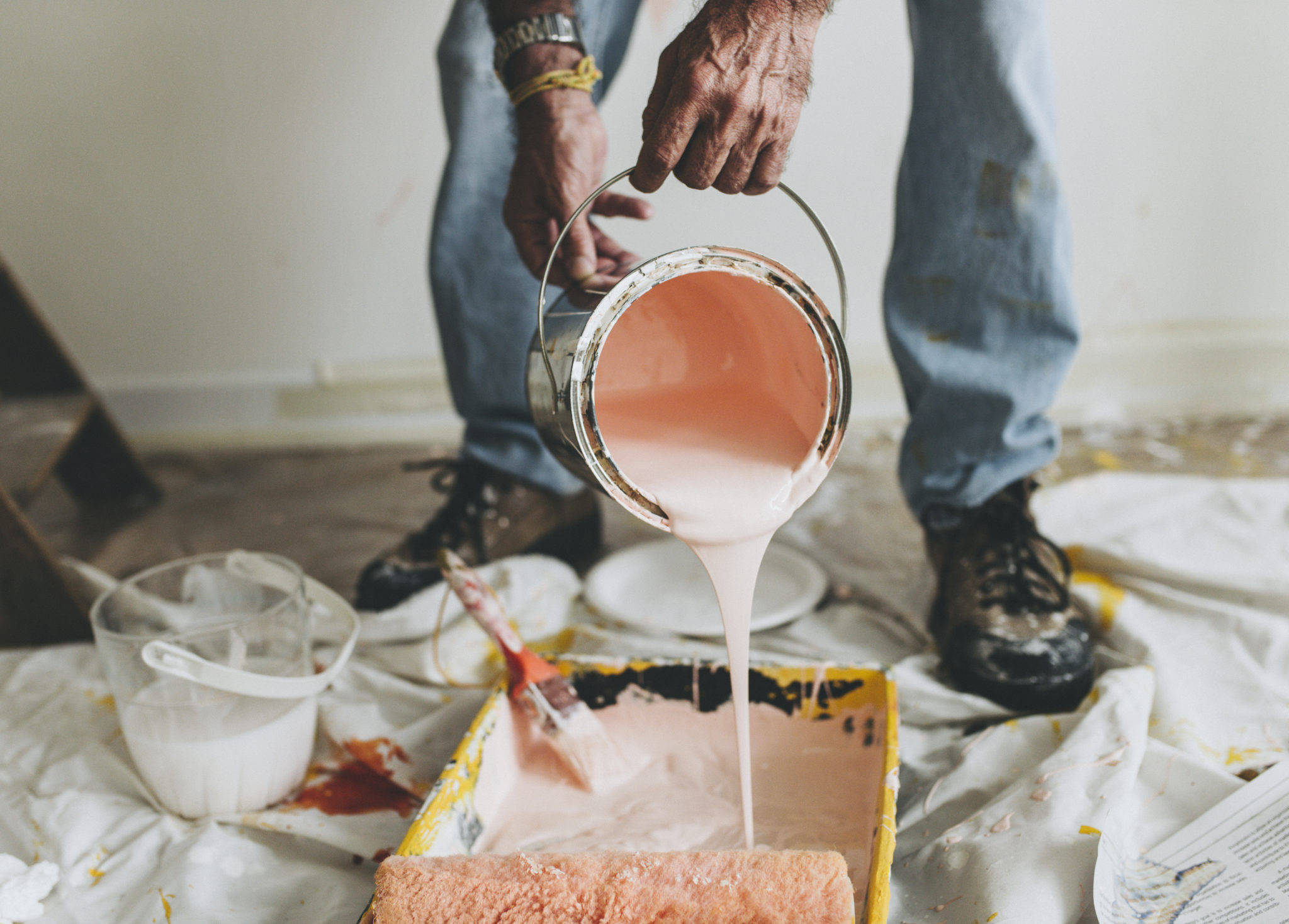 Pouring paint into a paint tray