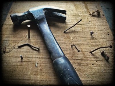 Black claw hammer on old wood plank