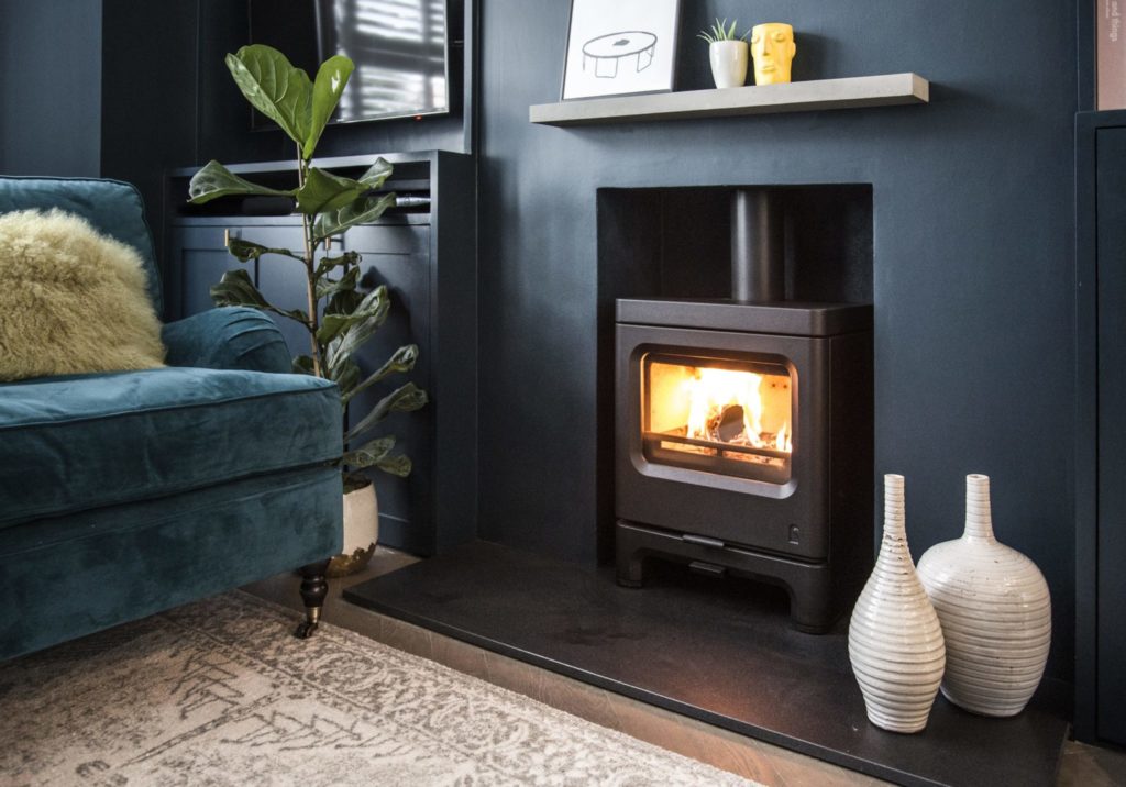 Wood stove in fireplace in modern home