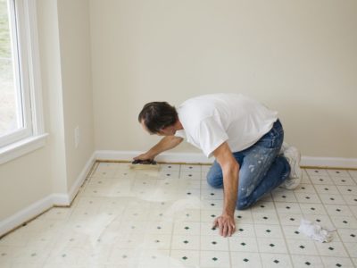 Man installing vinyl flooring