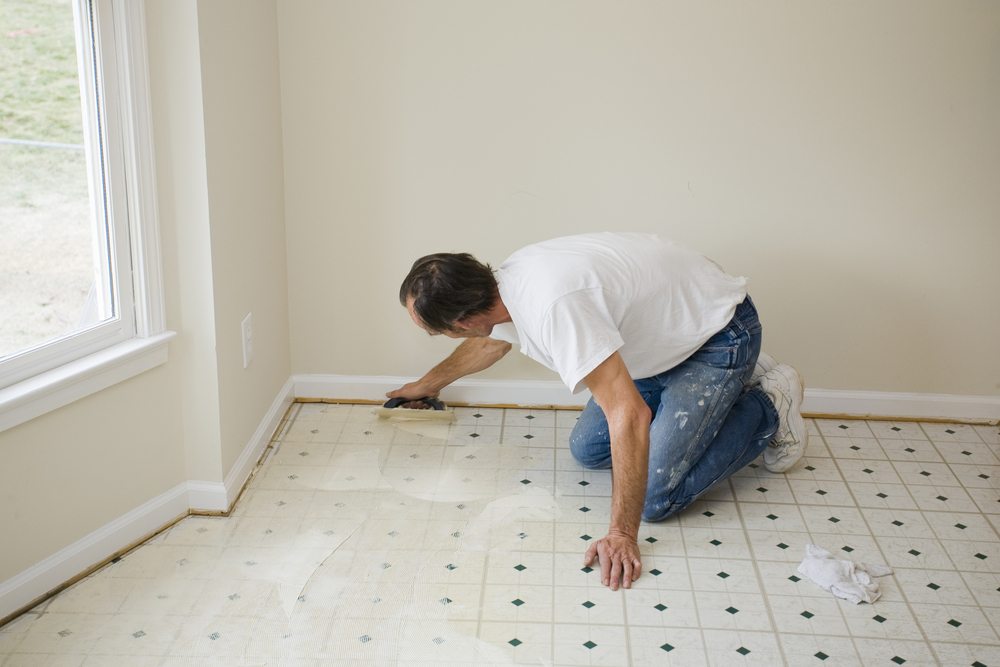 Man installing vinyl flooring