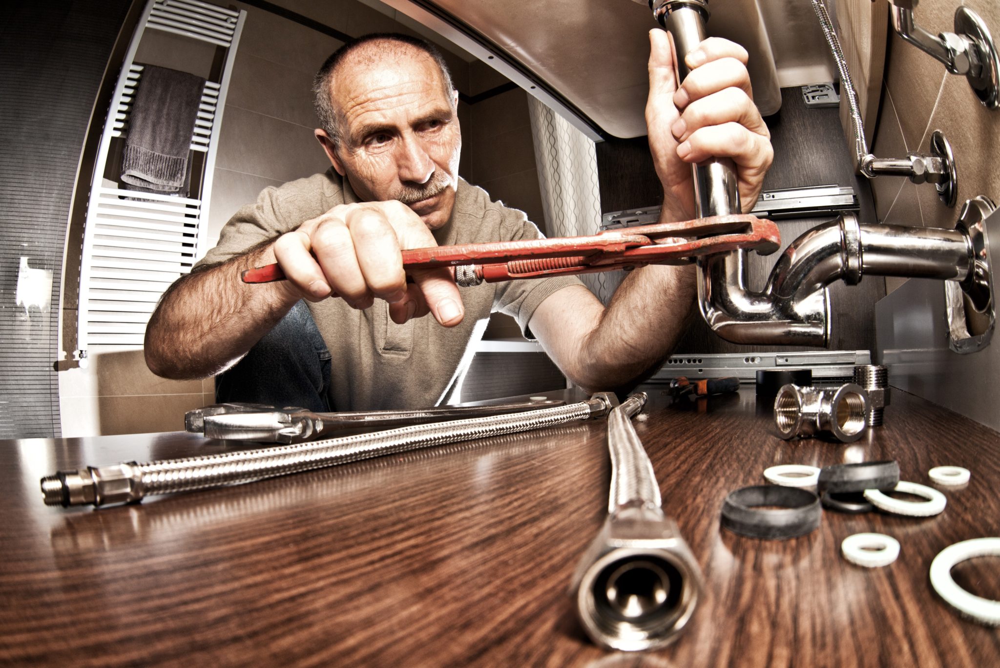 Plumber at work on pipes