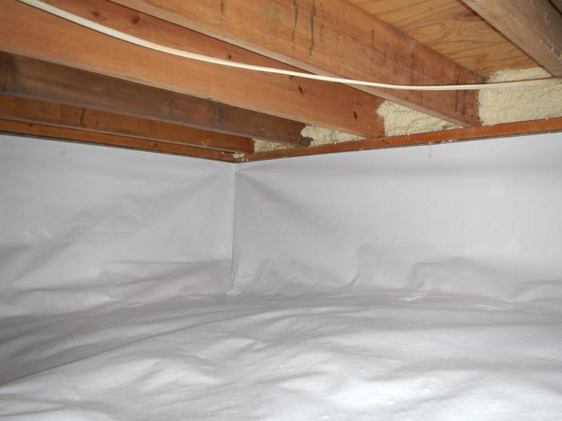 Crawlspace under a house with vapor barrier installed