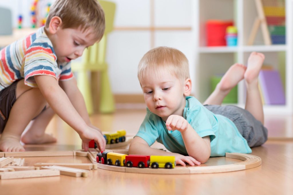 Kids playing with trains.