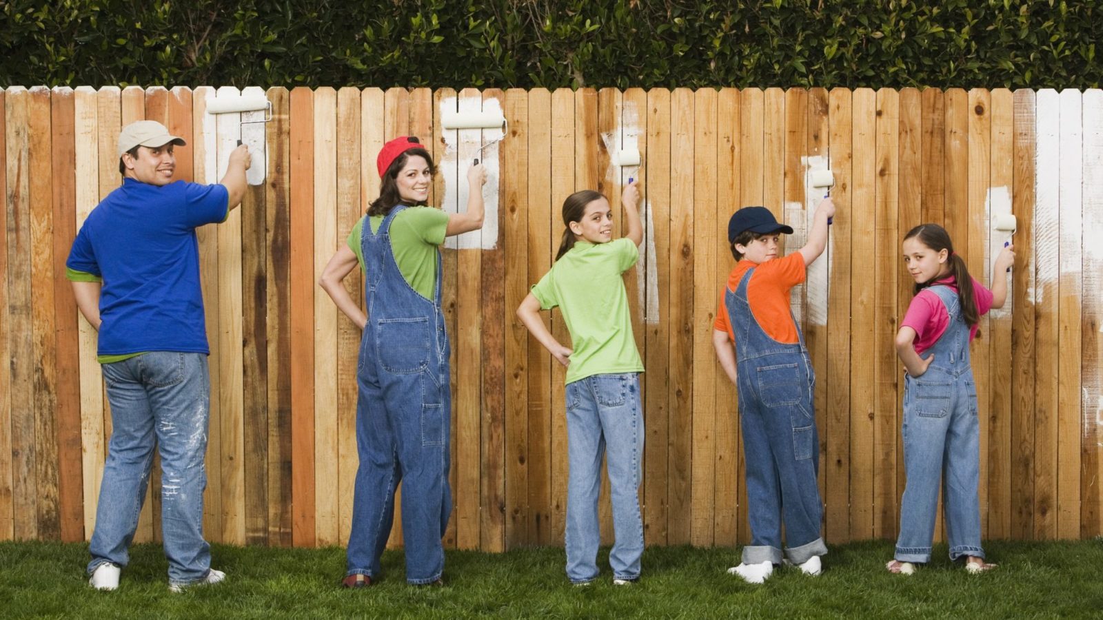 Family painting fence