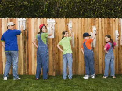 Family painting fence