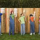 Family painting fence