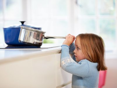 Child risking burn in kitchen