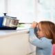 Child risking burn in kitchen