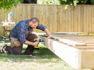 Man building a backyard deck