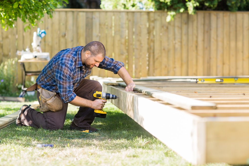 Man building a backyard deck