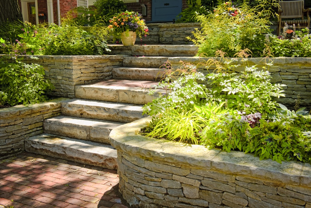 Stone retaining wall, steps and brick walkway