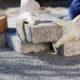 Brick patio pavers being placed on a gravel bed