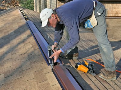 Man installing ridge vent