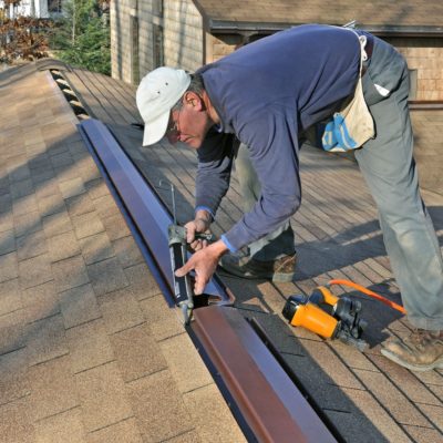 Man installing ridge vent