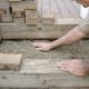 Man building brick paver patio steps