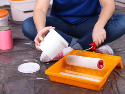 Pouring paint into a roller pan