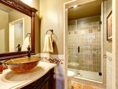 vanity, Bathroom interior in luxury house. Rich bathroom vanity cabinet with vessel sink and mirror. View of shower. Northwest, USA