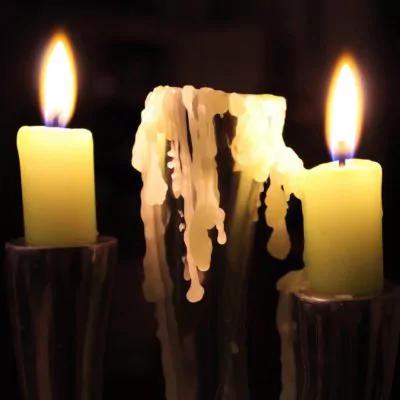 Dripping lit candle