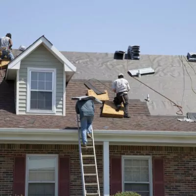 Workers replacing an older roof