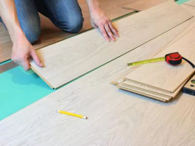 Installing laminate flooring over underlayment.