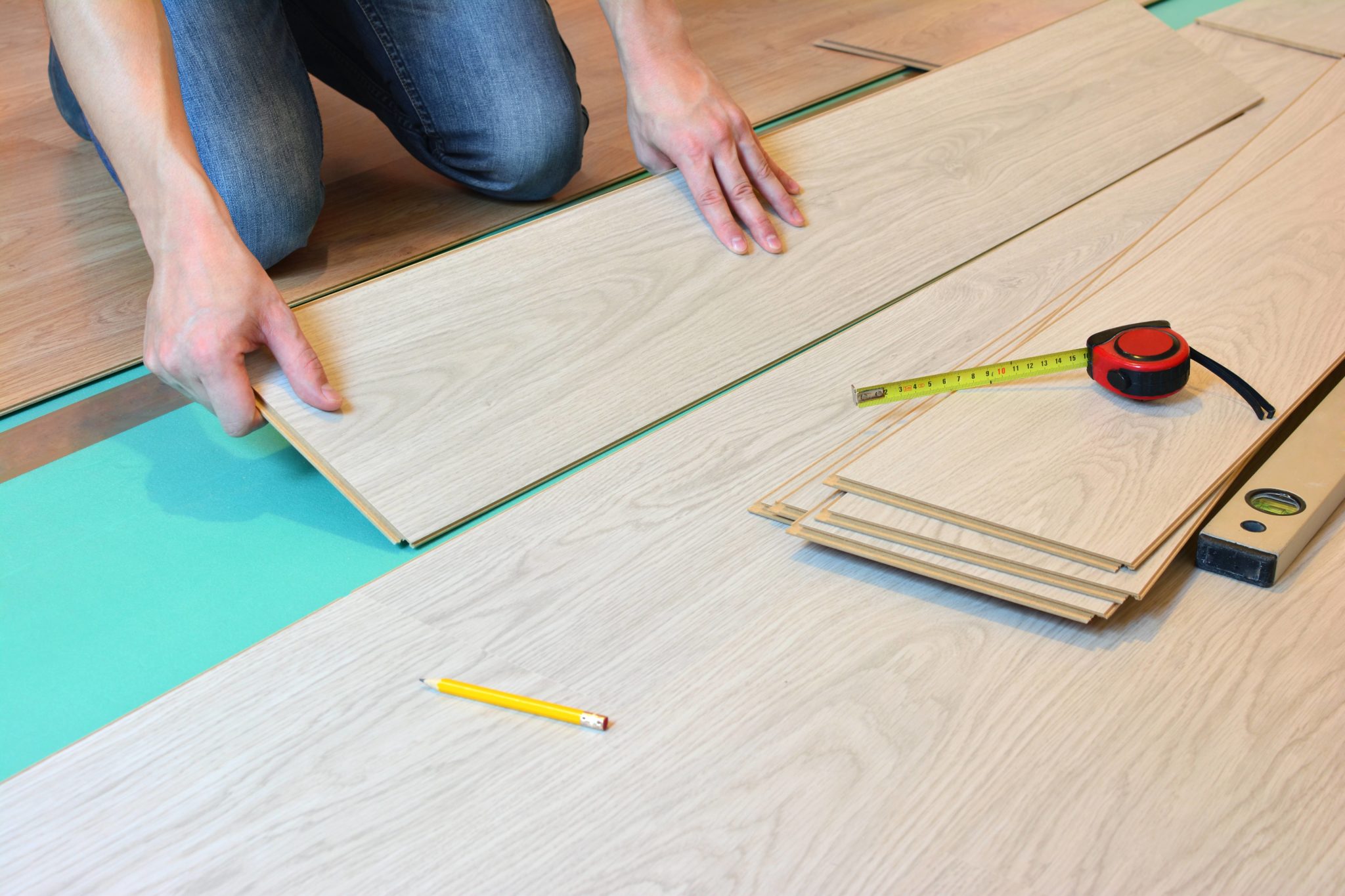 Installing laminate flooring over underlayment.