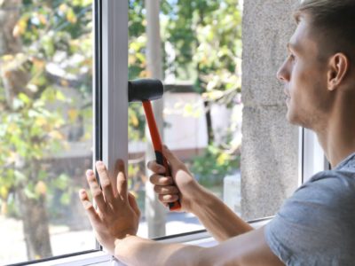 Man installing a replacement window