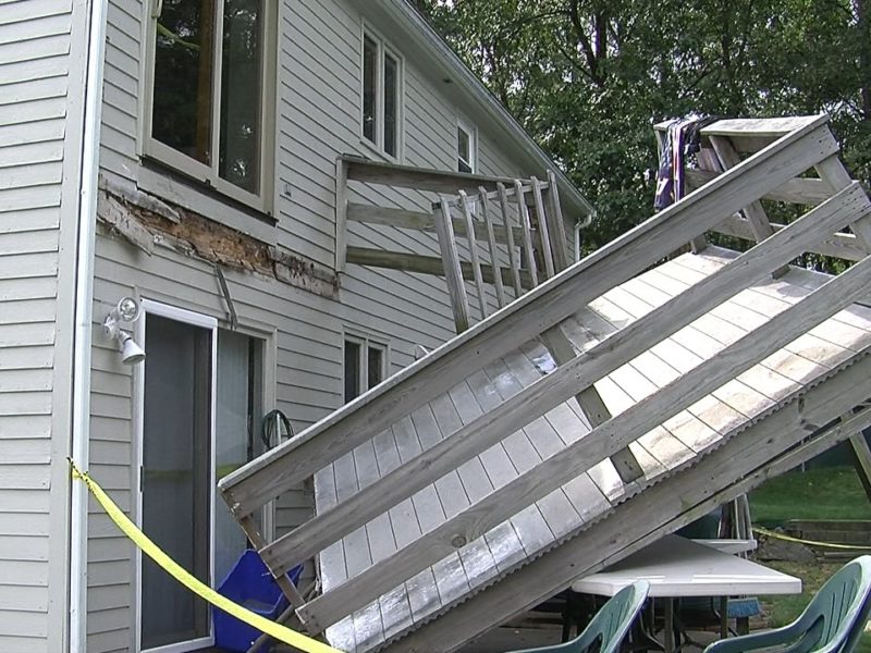 Deck collapsed behind house due to inadequate connection.
